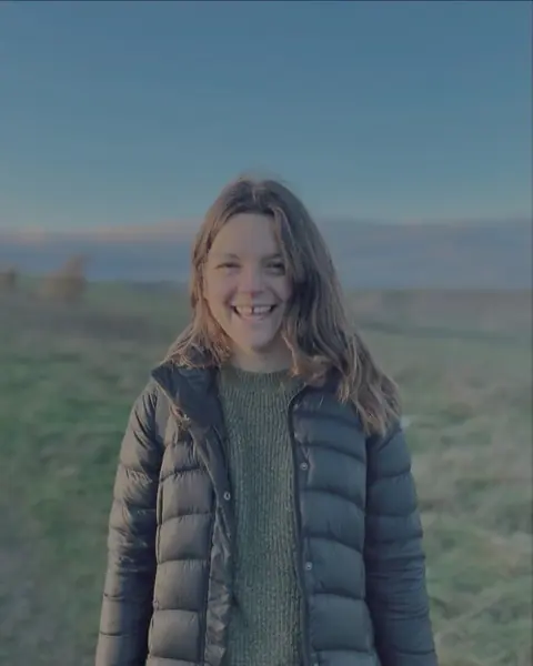 Hetty Henley smiling outdoors in the evening light